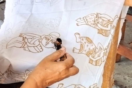 Making batik with canting